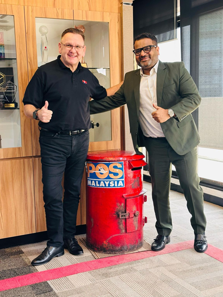 Charles Brewer of Pos Malaysia and Gautam Kumar of FarEye next to a Pos Malaysia postbox